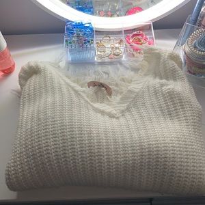 white ripped sweater